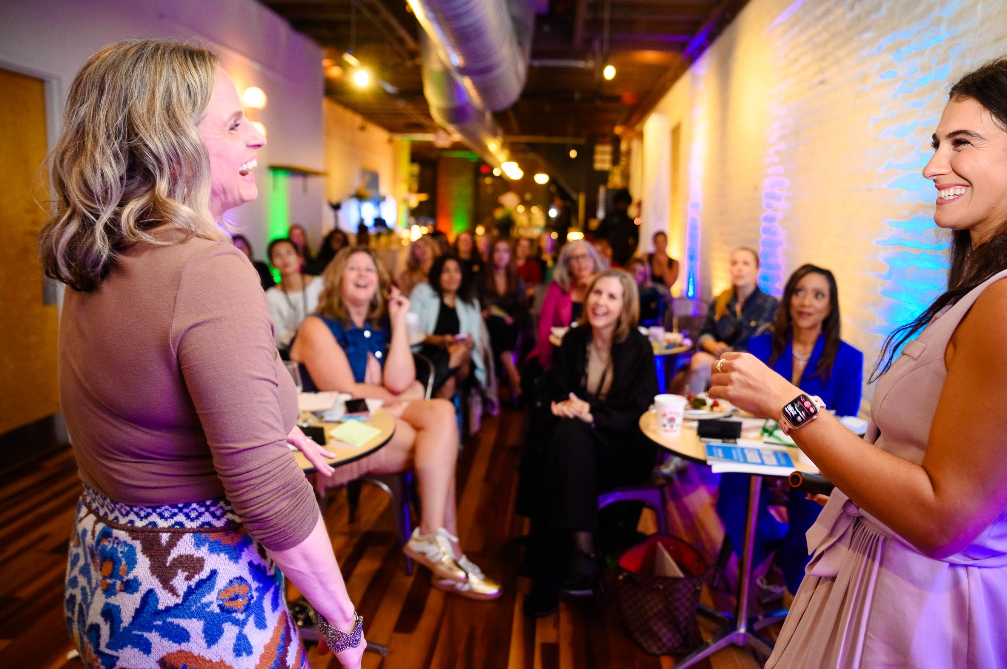 A BetterStory Studio Raleigh participant and Kristi Straw speak as the audience listens
