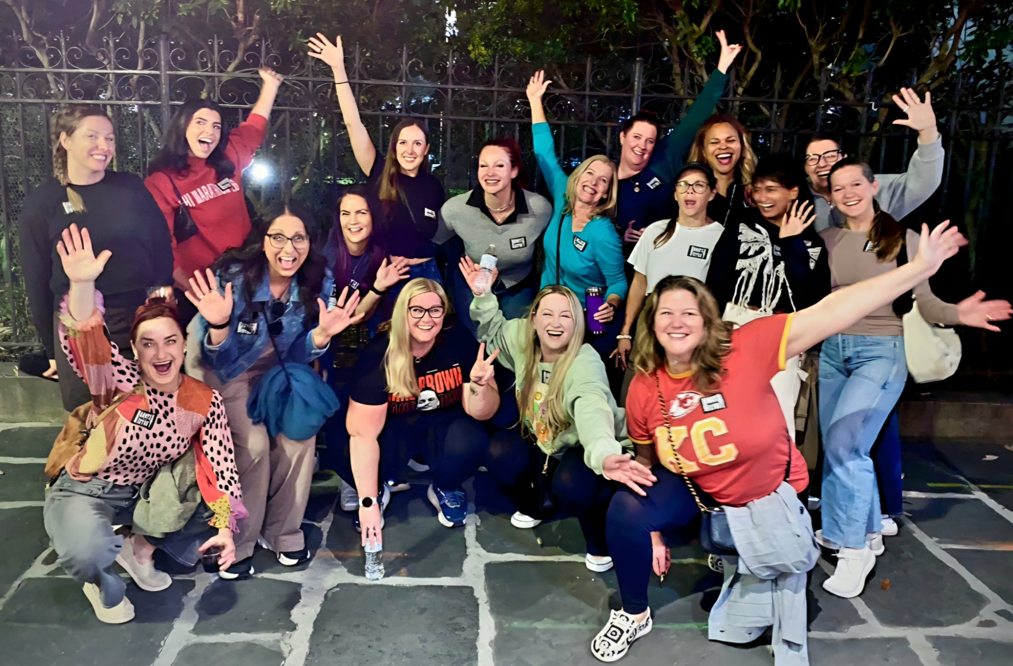 Women in Sales retreat attendees smiling and waving during a group photograph in New Orleans.